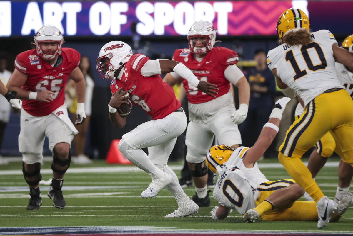 UNLV quarterback Hajj-Malik Williams (6) runs the ball past Cal linebacker Cade Uluave (0) duri ...