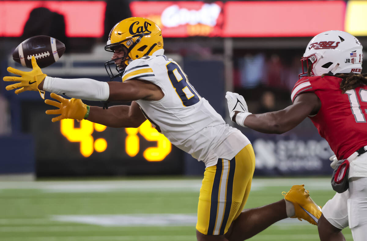 Cal wide receiver Jordan King (80) comes up short on the reception under pressure from UNLV def ...