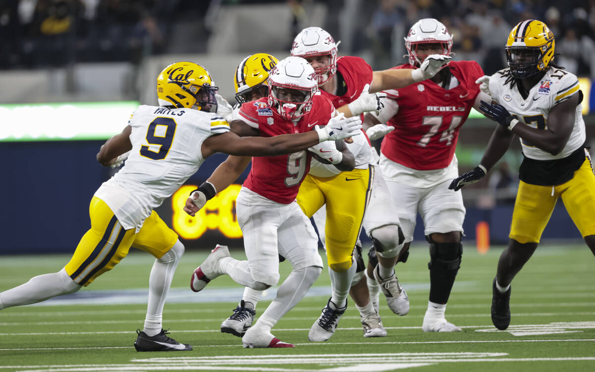 UNLV running back Jai'Den Thomas (9) runs the ball under pressure from Cal defensive back Ryan ...