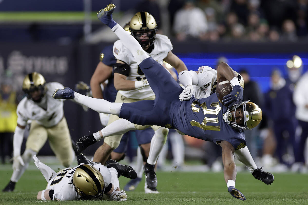 Notre Dame running back Jadarian Price (24) is tackled by an Army defender during the first hal ...