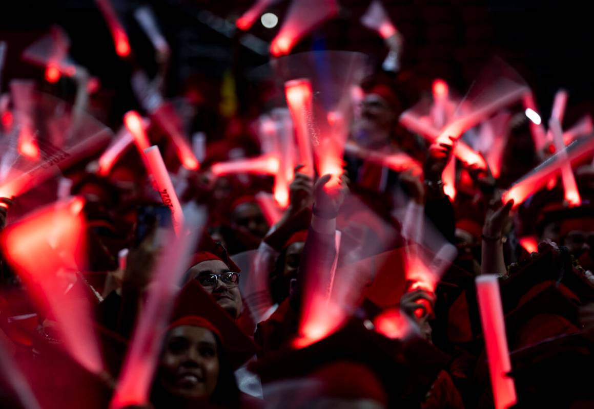 Graduates wave glow sticks after moving their tassels during the UNLV winter commencement at th ...