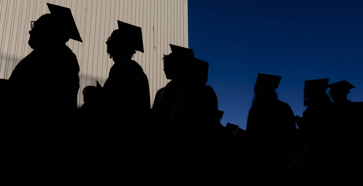 Graduates wait in line before the UNLV winter commencement outside the Thomas & Mack Center ...