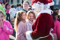 Gladys Moore and Stevie Frabbiele react as they meet Mrs Claus as local firefighters deliver to ...