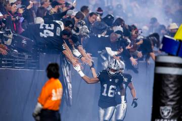 Raiders players gtreet fans as they run onto the field to face the Atlanta Falcons safety Justi ...