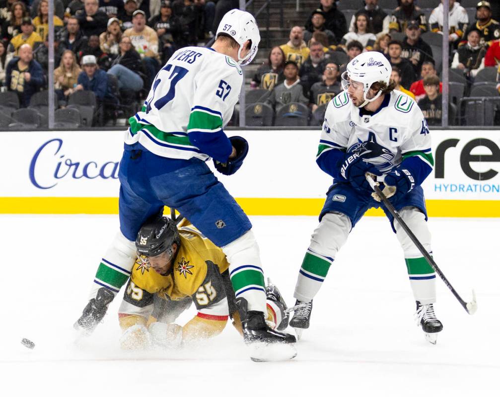 Golden Knights right wing Keegan Kolesar (55) dives after the puck under Vancouver Canucks defe ...