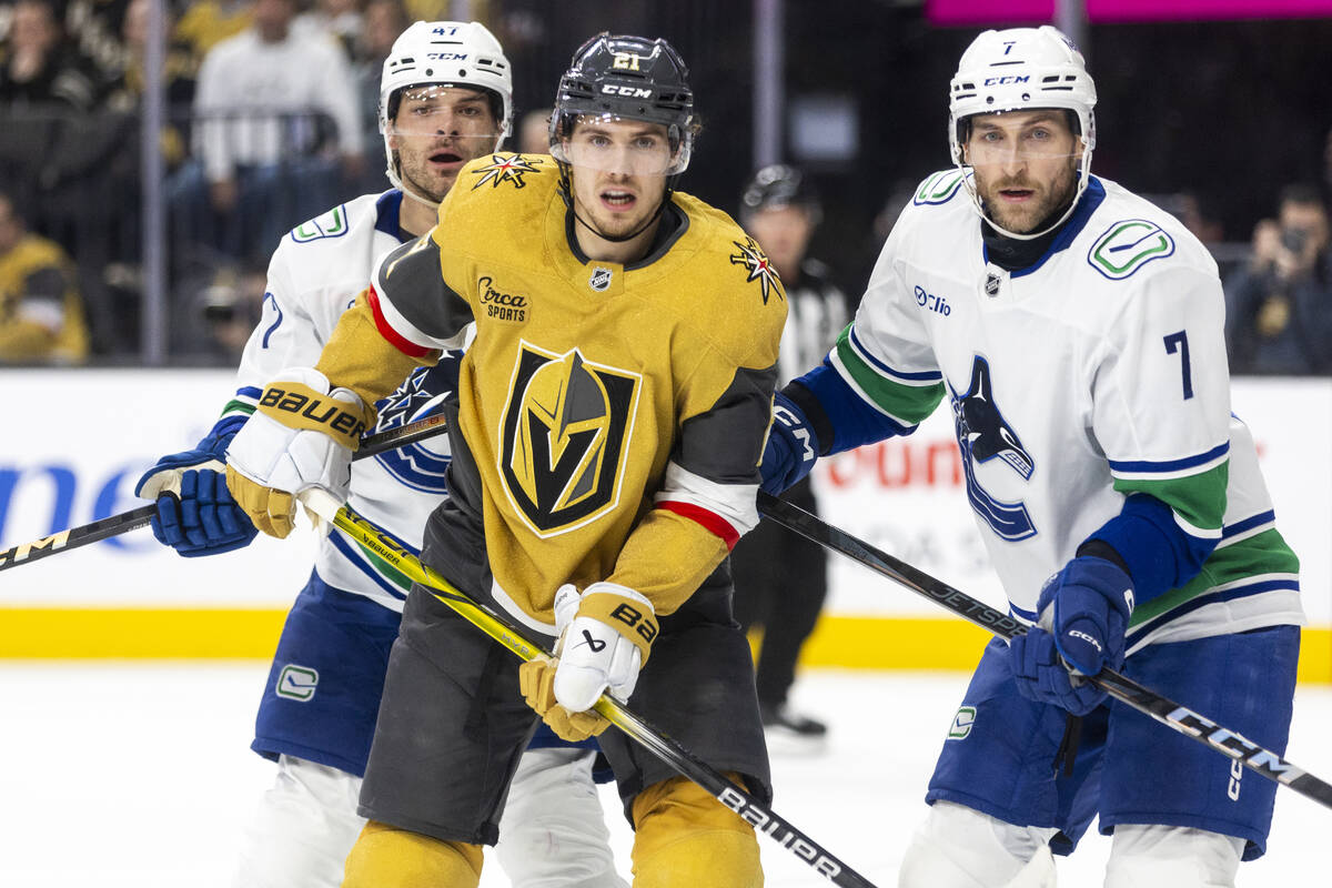 Vancouver Canucks defenseman Noah Juulsen (47), Golden Knights center Brett Howden (21) and Van ...