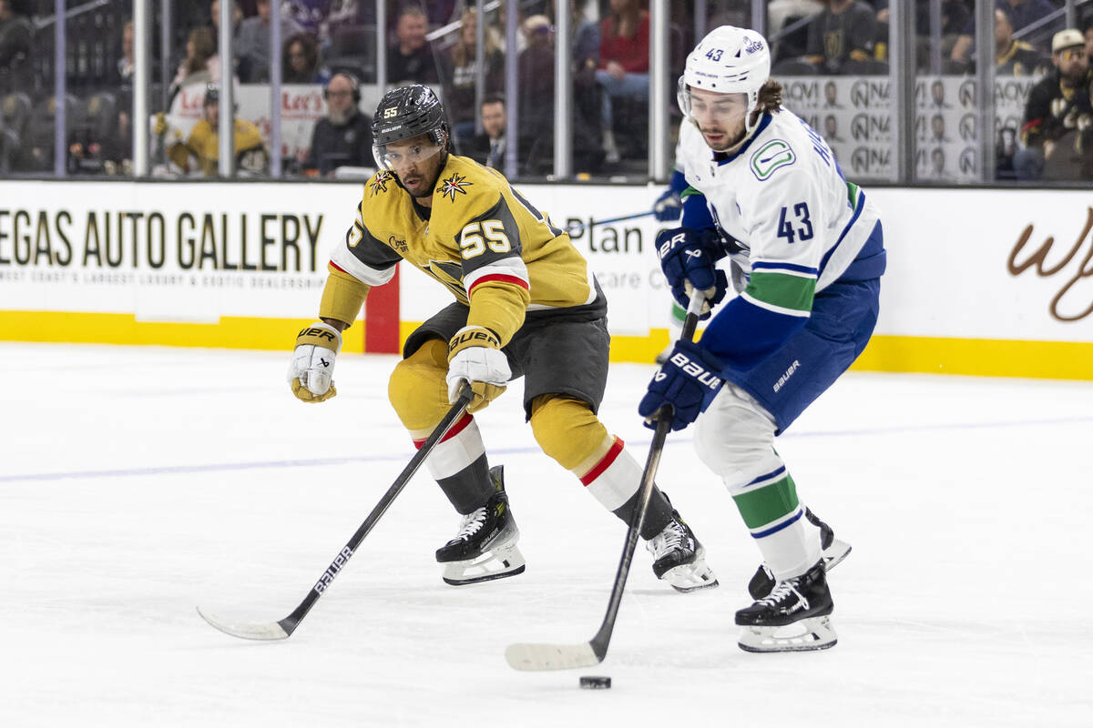 Golden Knights right wing Keegan Kolesar (55) and Vancouver Canucks defenseman Quinn Hughes (43 ...