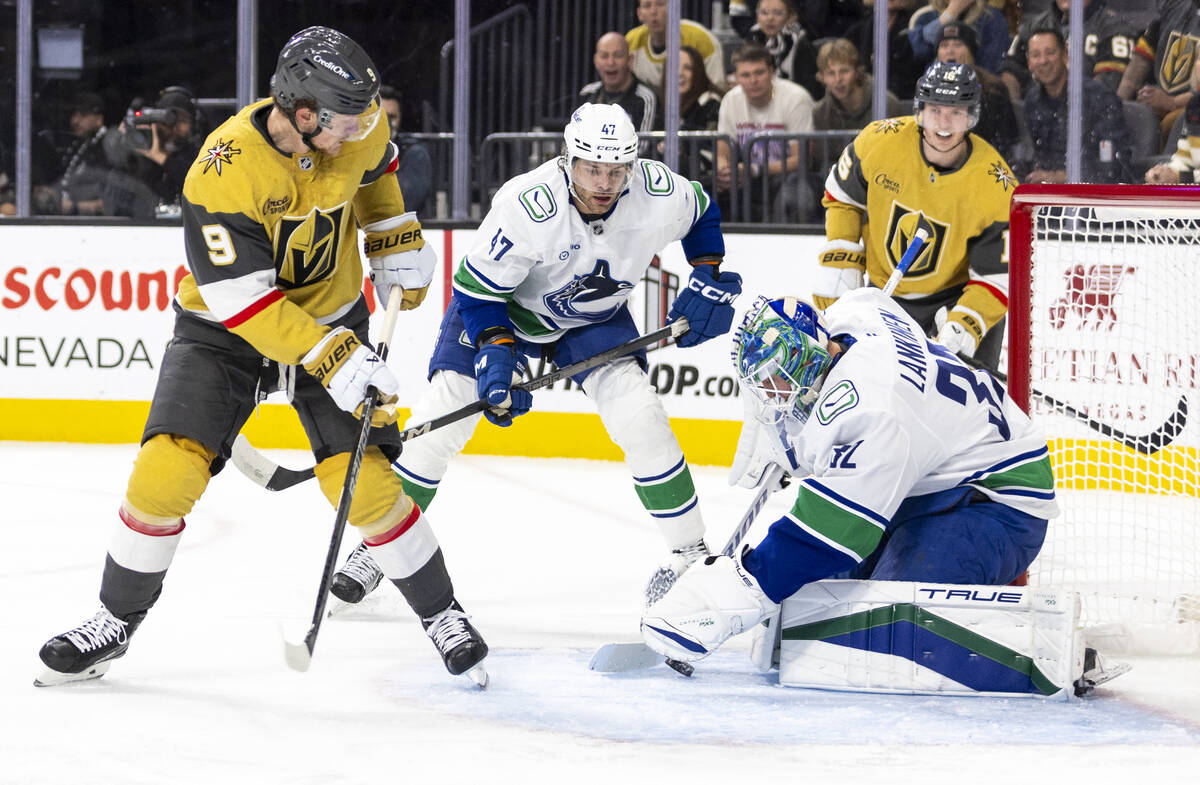 Vancouver Canucks goaltender Kevin Lankinen (32) covers the puck during the first period of the ...