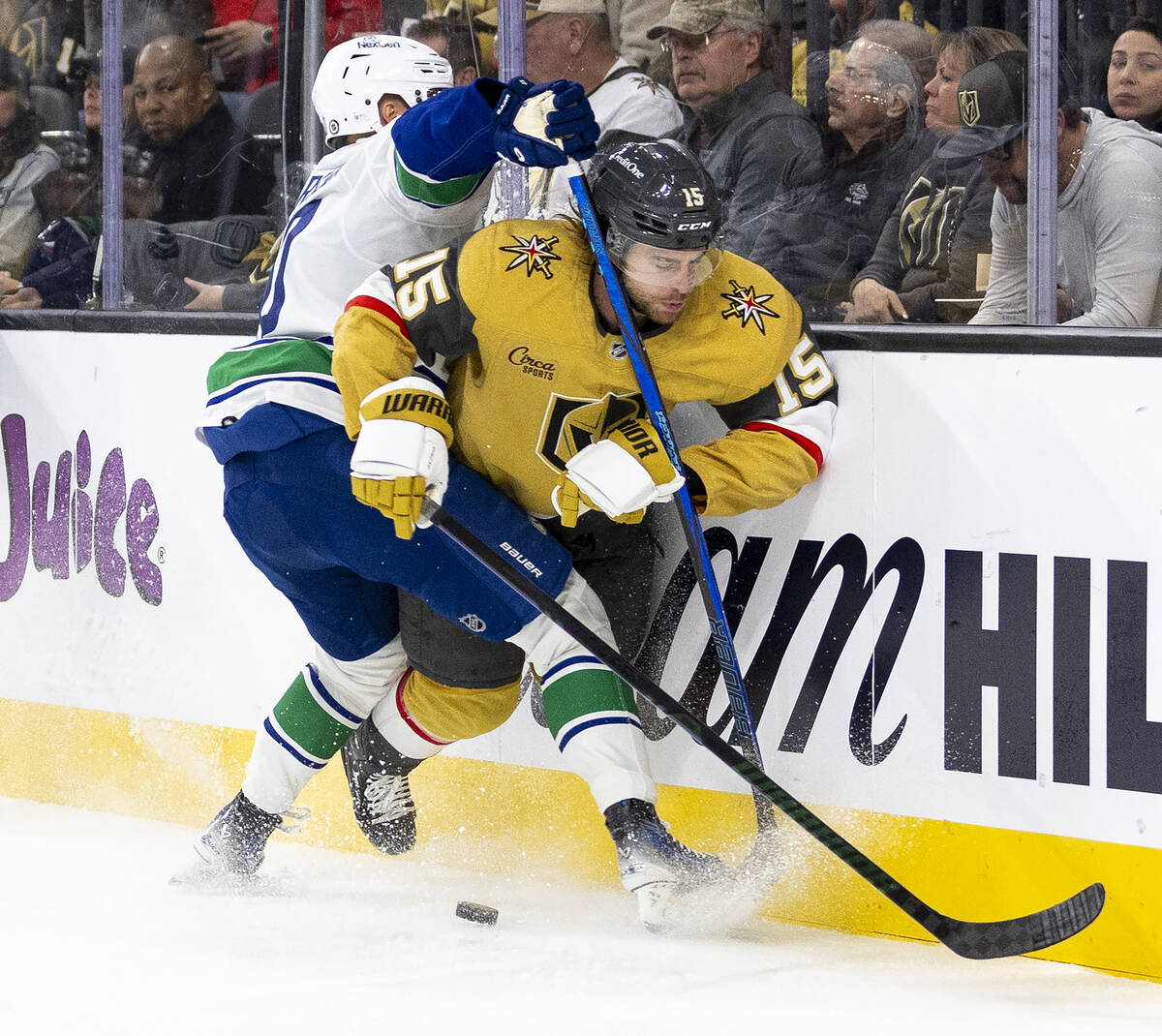 Vancouver Canucks center Elias Pettersson, left, shoves Golden Knights defenseman Noah Hanifin ...