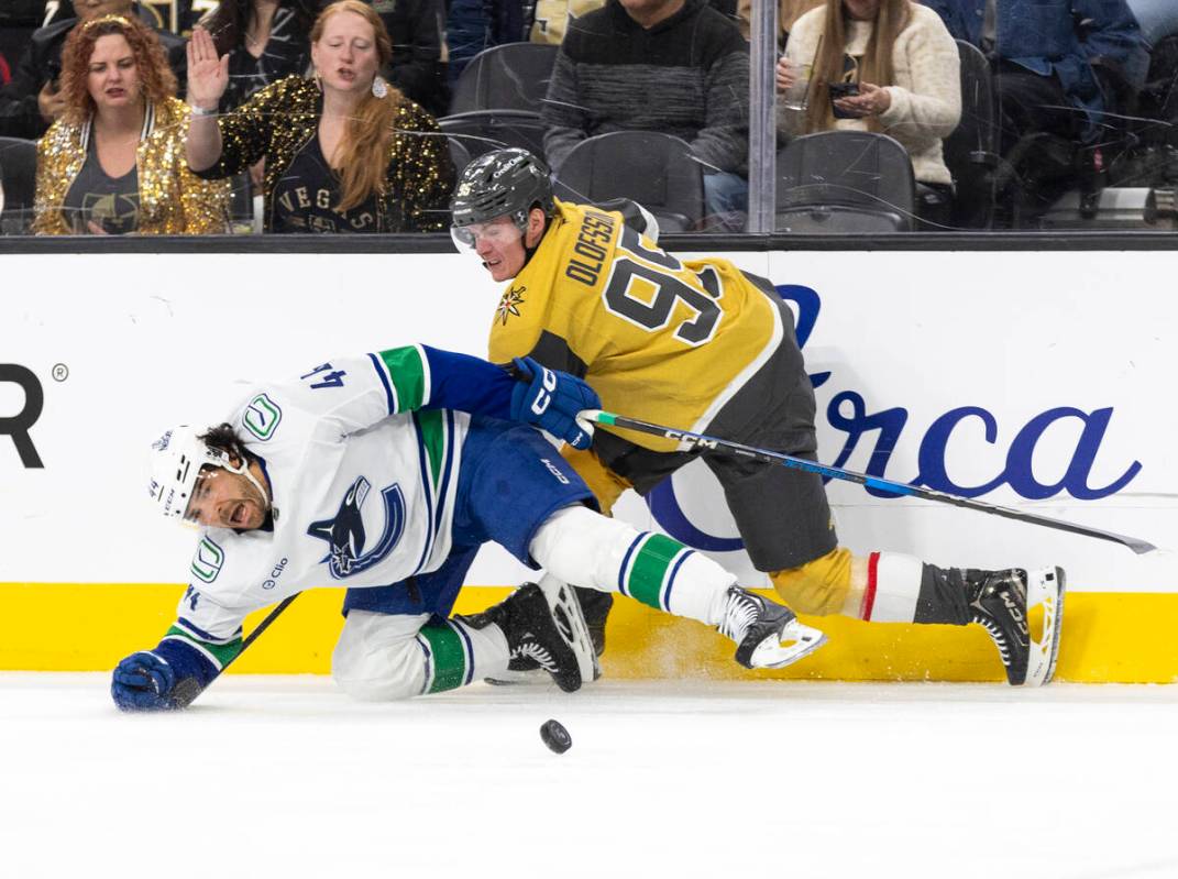 Golden Knights right wing Victor Olofsson (95) and Vancouver Canucks left wing Kiefer Sherwood ...