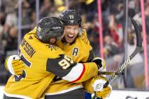 Golden Knights center William Karlsson (71) is hugged by right wing Victor Olofsson (95) after ...