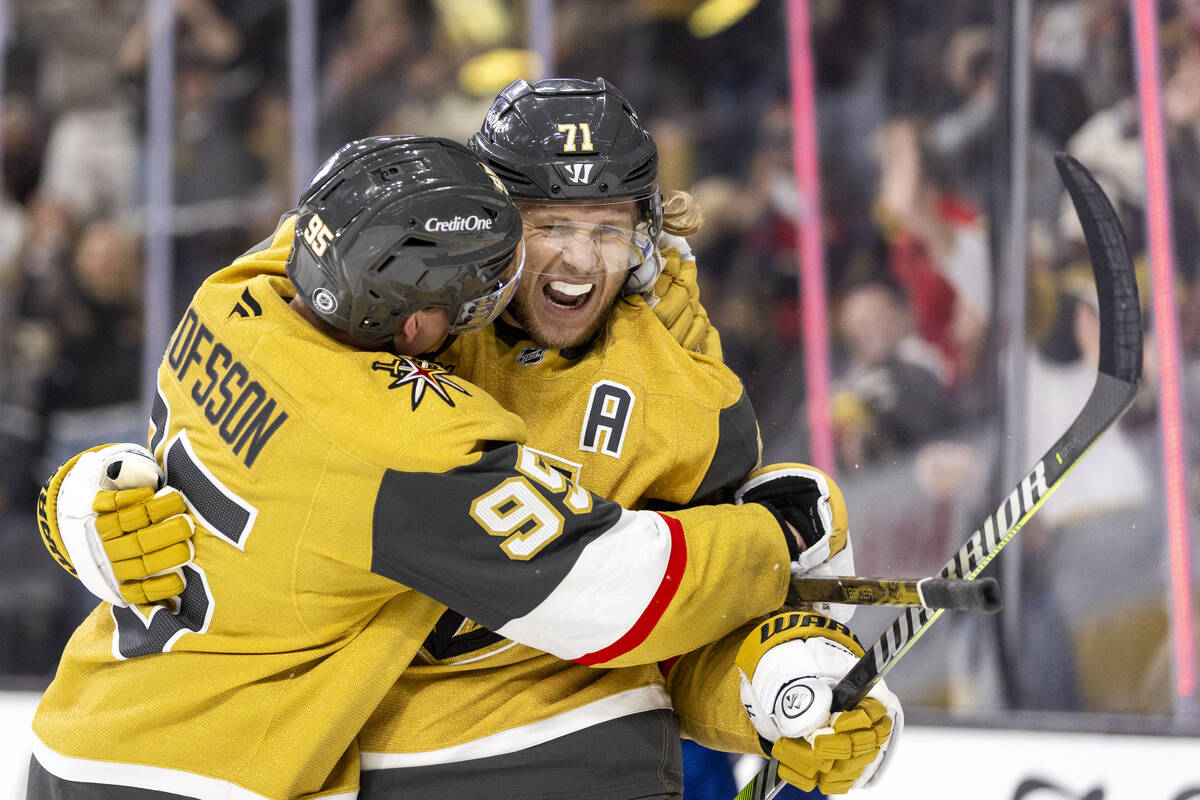 Golden Knights center William Karlsson (71) is hugged by right wing Victor Olofsson (95) after ...