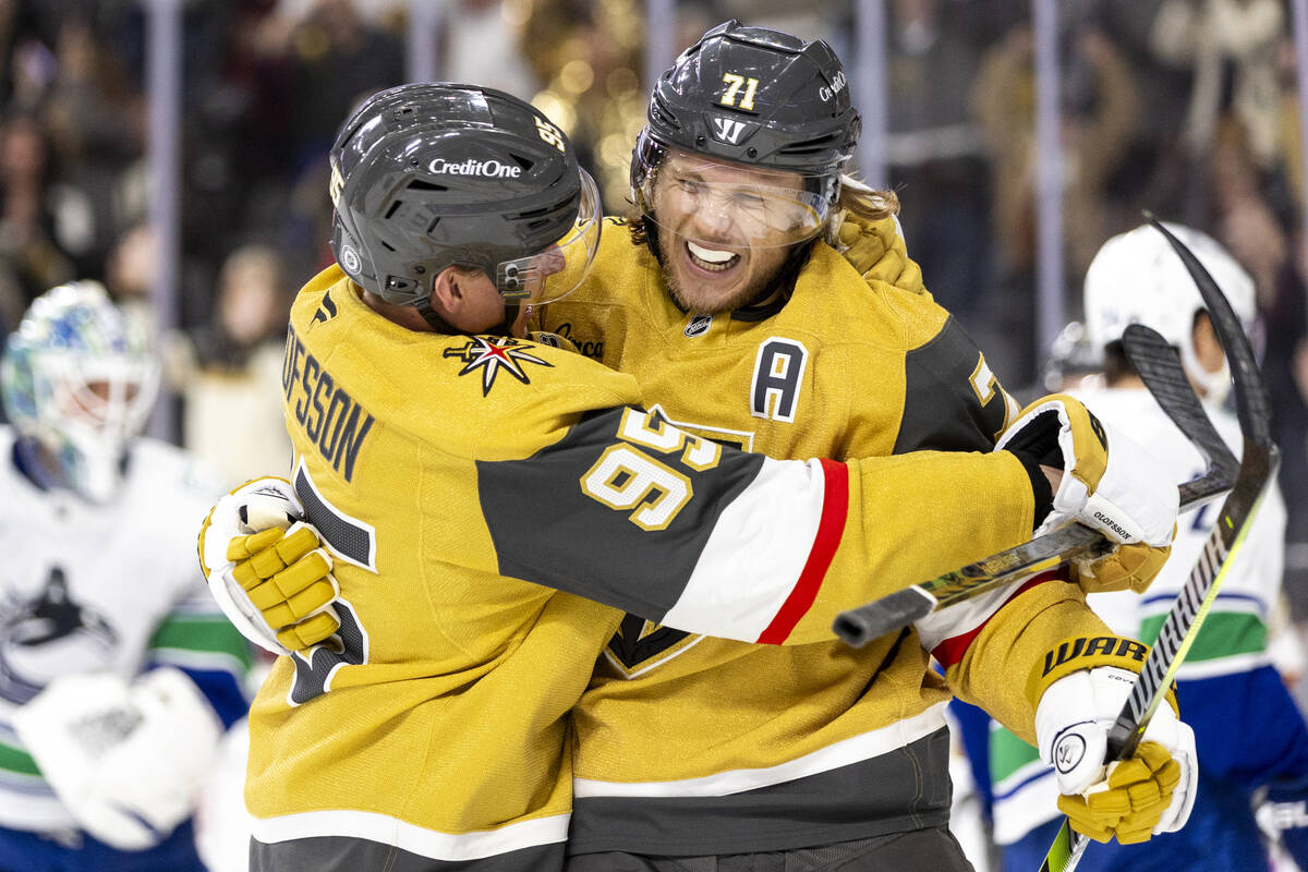 Golden Knights center William Karlsson (71) is hugged by right wing Victor Olofsson (95) after ...