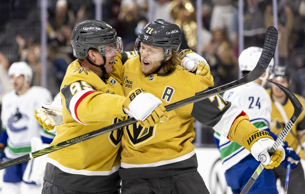 Golden Knights center William Karlsson (71) is hugged by right wing Victor Olofsson (95) after ...