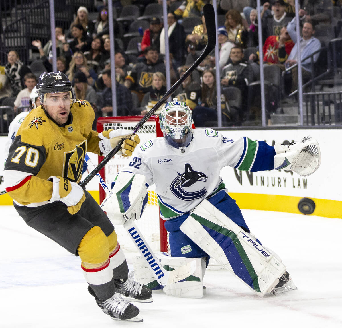 Golden Knights left wing Tanner Pearson (70) and Vancouver Canucks goaltender Kevin Lankinen (3 ...