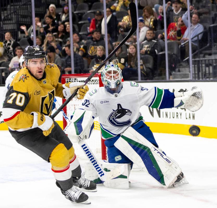 Golden Knights left wing Tanner Pearson (70) and Vancouver Canucks goaltender Kevin Lankinen (3 ...