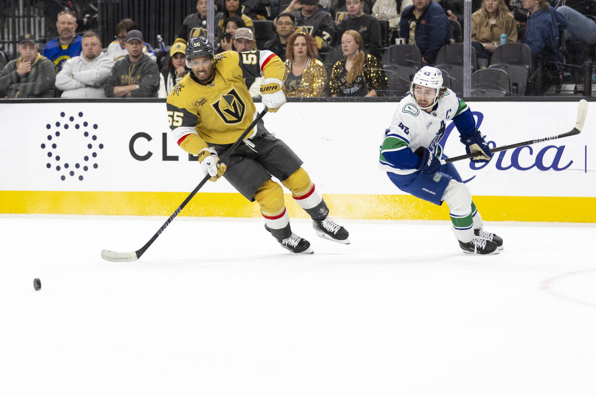 Golden Knights right wing Keegan Kolesar (55) and Vancouver Canucks defenseman Quinn Hughes (43 ...