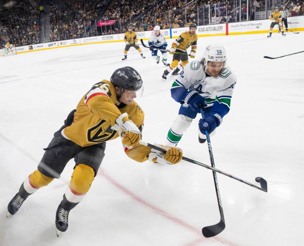 Golden Knights left wing Pavel Dorofeyev (16) passes the puck past Vancouver Canucks center Ted ...