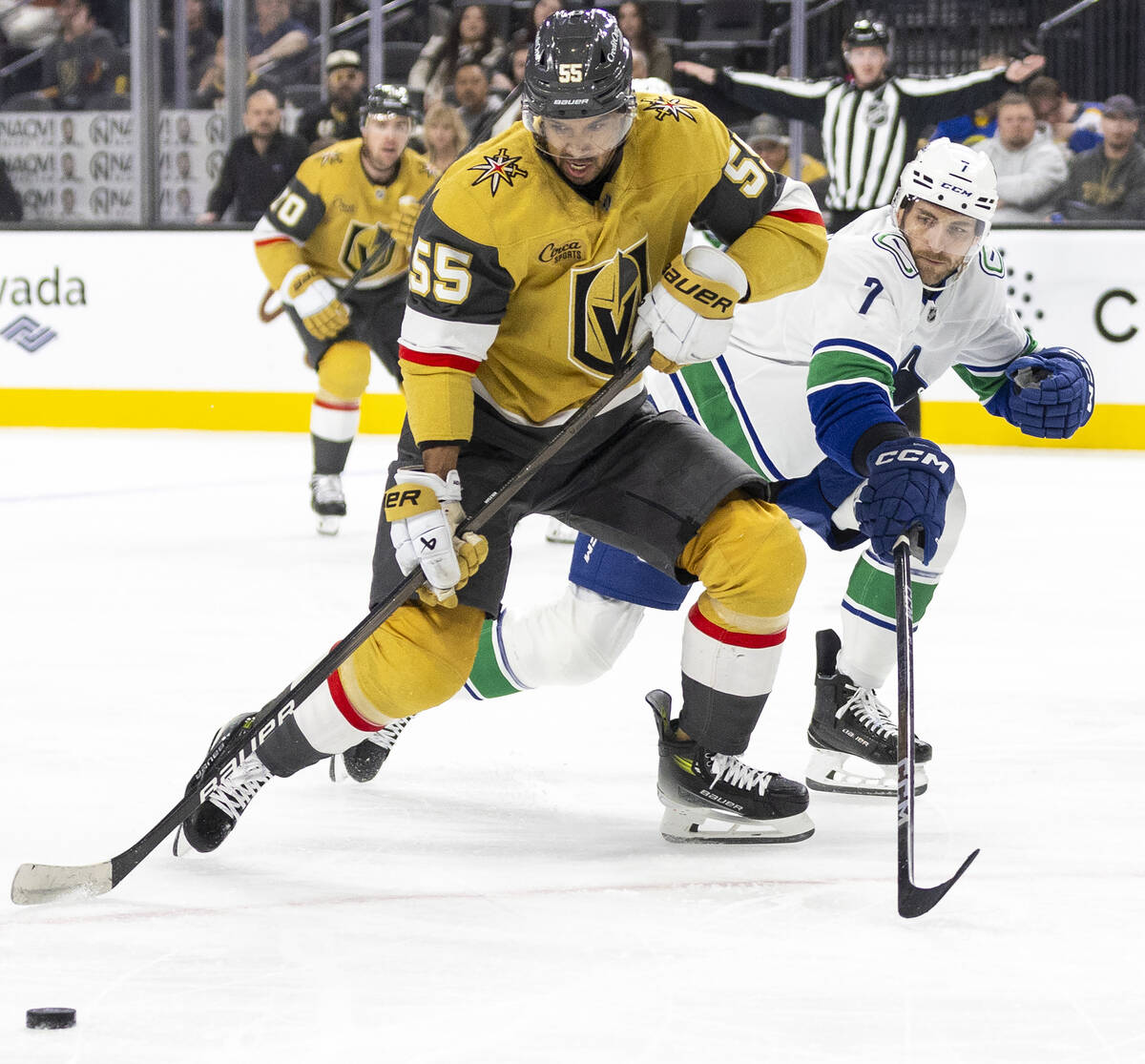 Golden Knights right wing Keegan Kolesar (55) keeps the puck from Vancouver Canucks defenseman ...