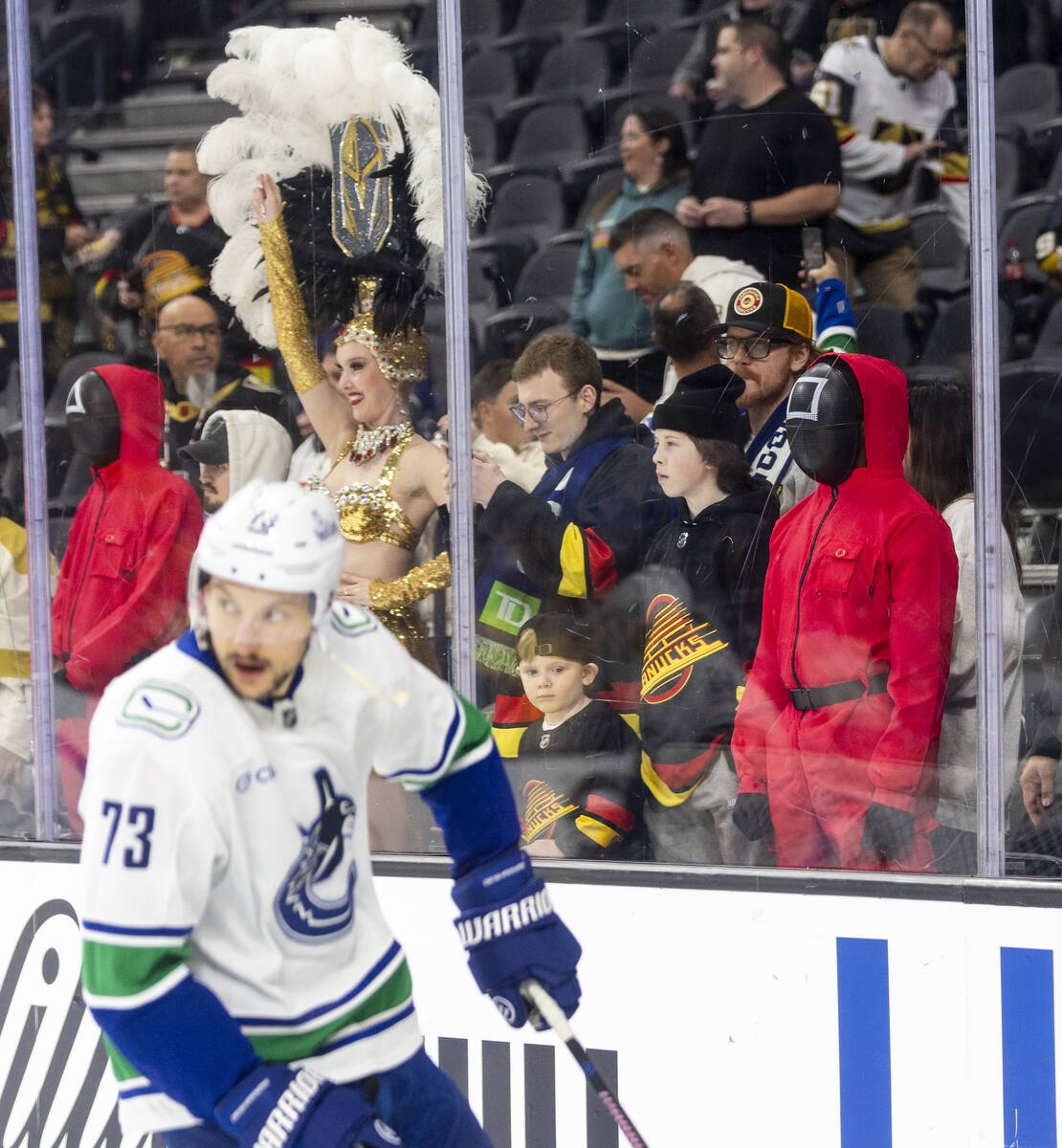 A guard from the popular Netflix series Squid Games watches the Vancouver Canucks warmup before ...