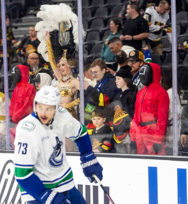 A guard from the popular Netflix series Squid Games watches the Vancouver Canucks warmup before ...