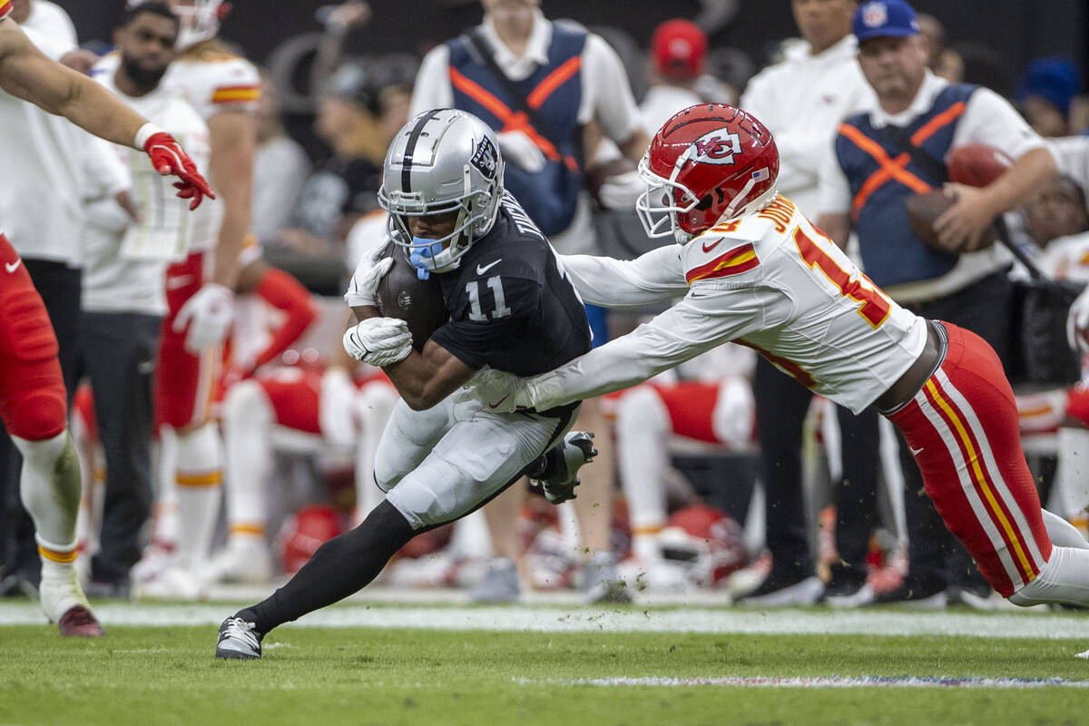 Raiders wide receiver Tre Tucker (11) is tackled after a catch by Kansas City Chiefs safety Naz ...