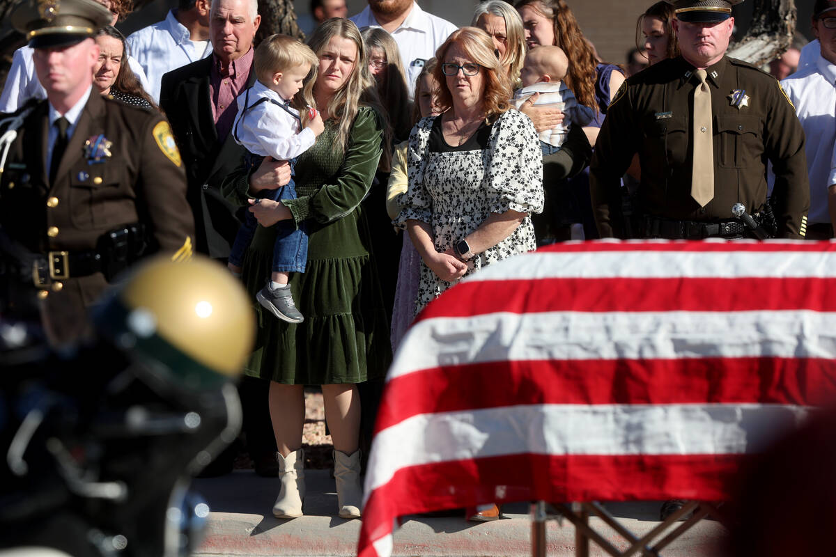 Ashlee Pulsipher, widow of Las Vegas police officer Colton Pulsipher, center, watches the caske ...