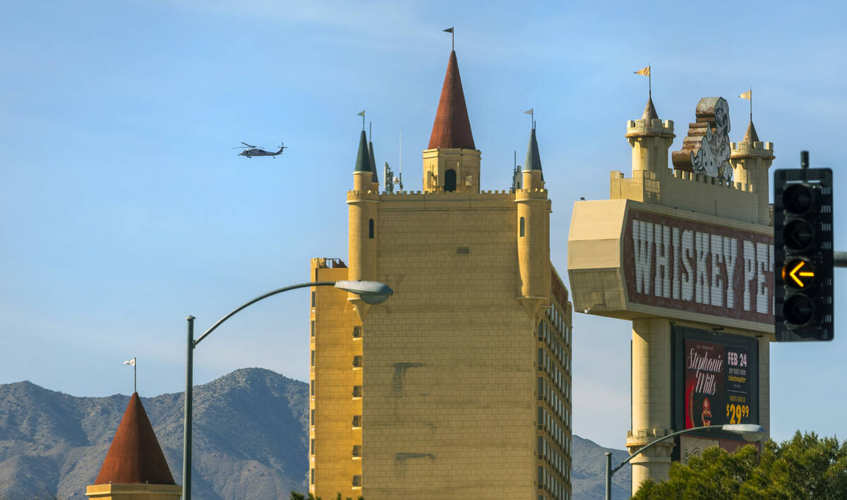 A helicopter cruises beyond the Whiskey Pete's Hotel & Casino on Friday, Jan. 26, 2024, in ...