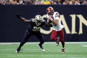 Washington Commanders quarterback Jayden Daniels (5) runs the ball in front of New Orleans Sain ...