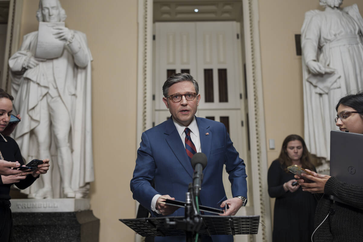 Speaker of the House Mike Johnson, R-La., talks briefly to reporters just before a vote on an i ...