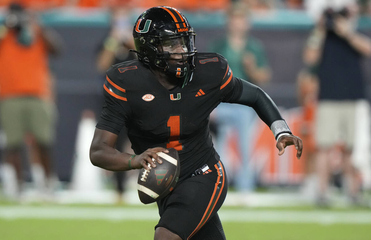 Miami quarterback Cam Ward (1) looks to pass during the first half of an NCAA college football ...