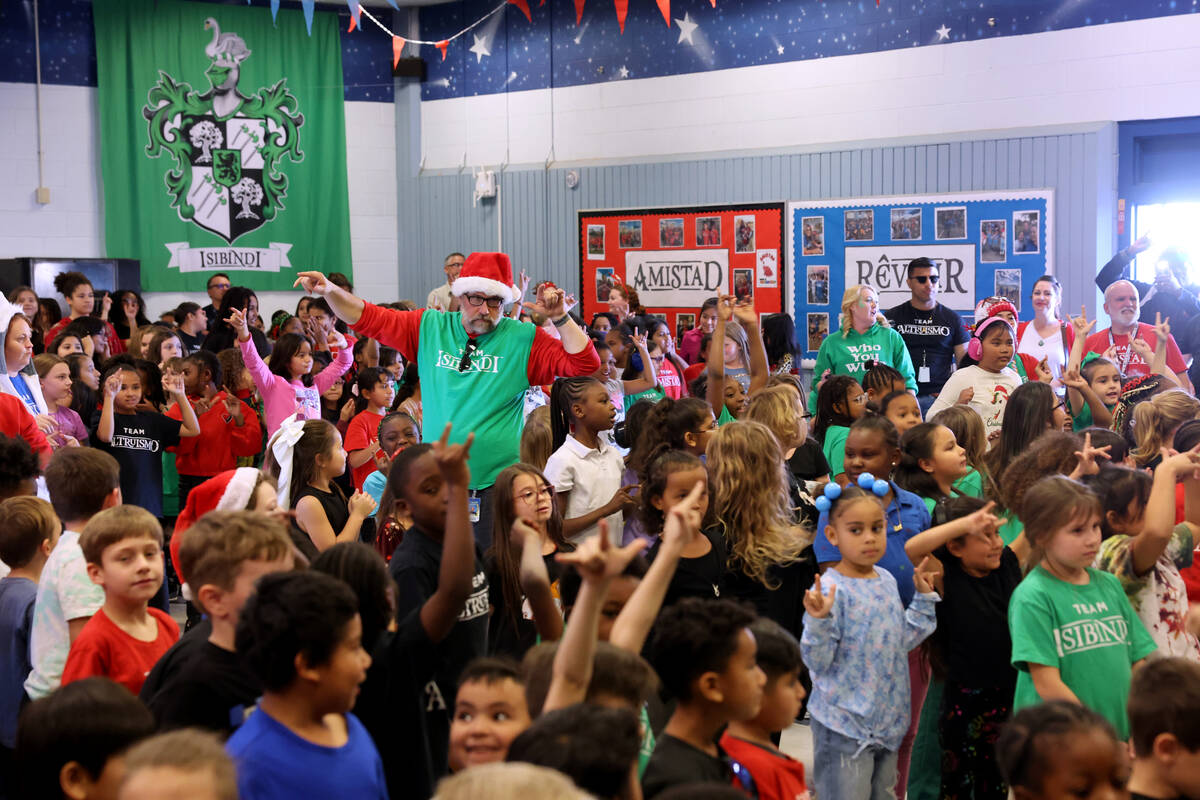 P.E. teacher Jim Dolan gets students fired up for a holiday party at Sewell Elementary School i ...