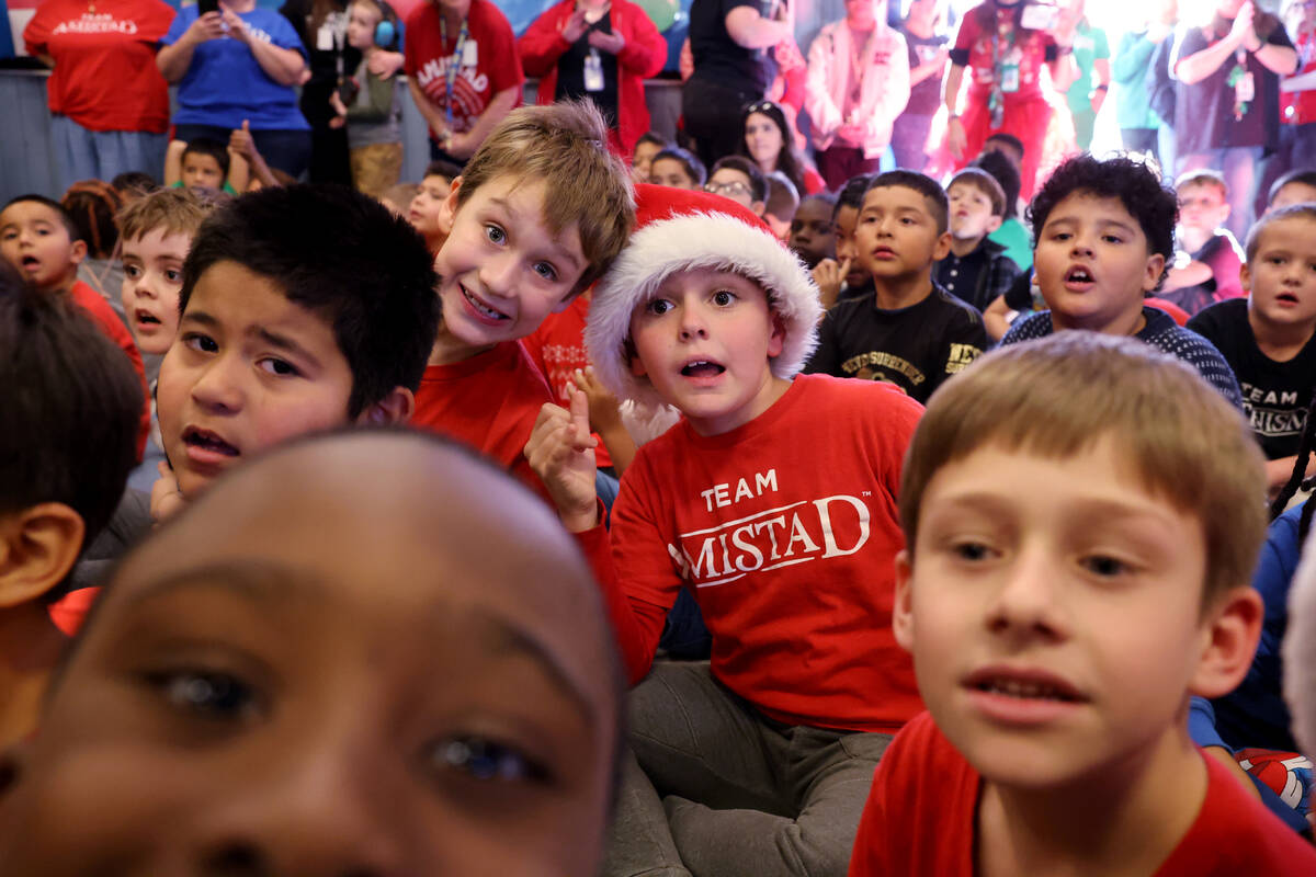 Students, including Gaige Nava, left, Connor Hawken, get fired up during a holiday party at Sew ...