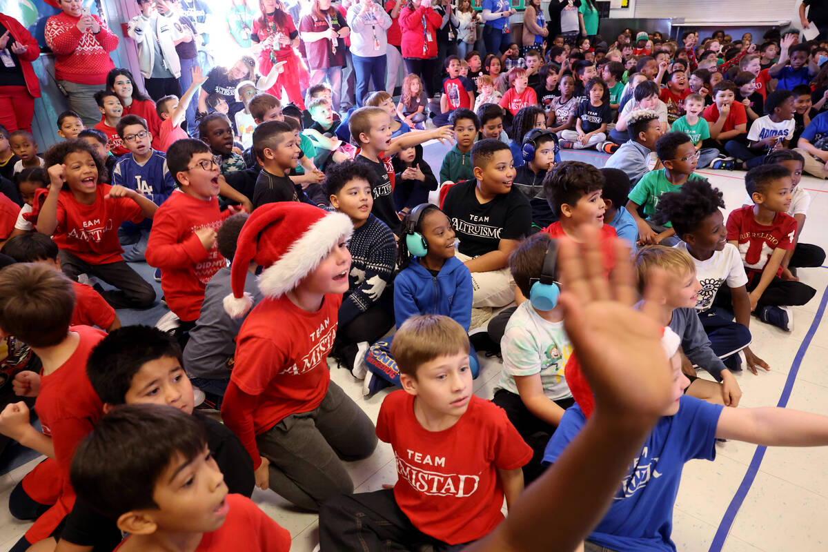 Students get fired up during a holiday party at Sewell Elementary School in Henderson Friday De ...