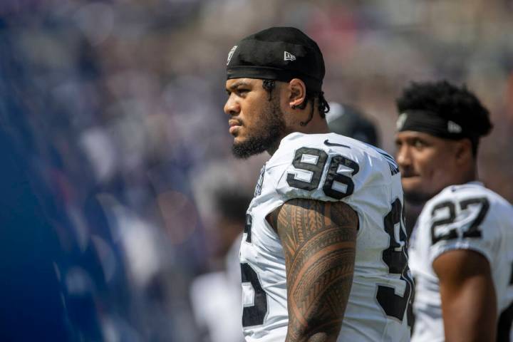 Raiders defensive tackle Jonah Laulu (96) looks on from the sideline before the start of an NFL ...