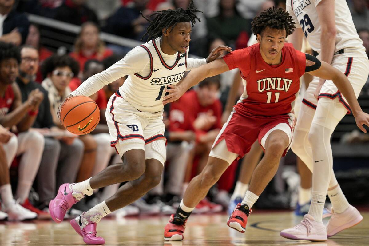 Dayton guard Malachi Smith (11) dribbles against UNLV guard Dedan Thomas Jr. (11) during an NCA ...