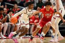 Dayton guard Malachi Smith (11) dribbles against UNLV guard Dedan Thomas Jr. (11) during an NCA ...