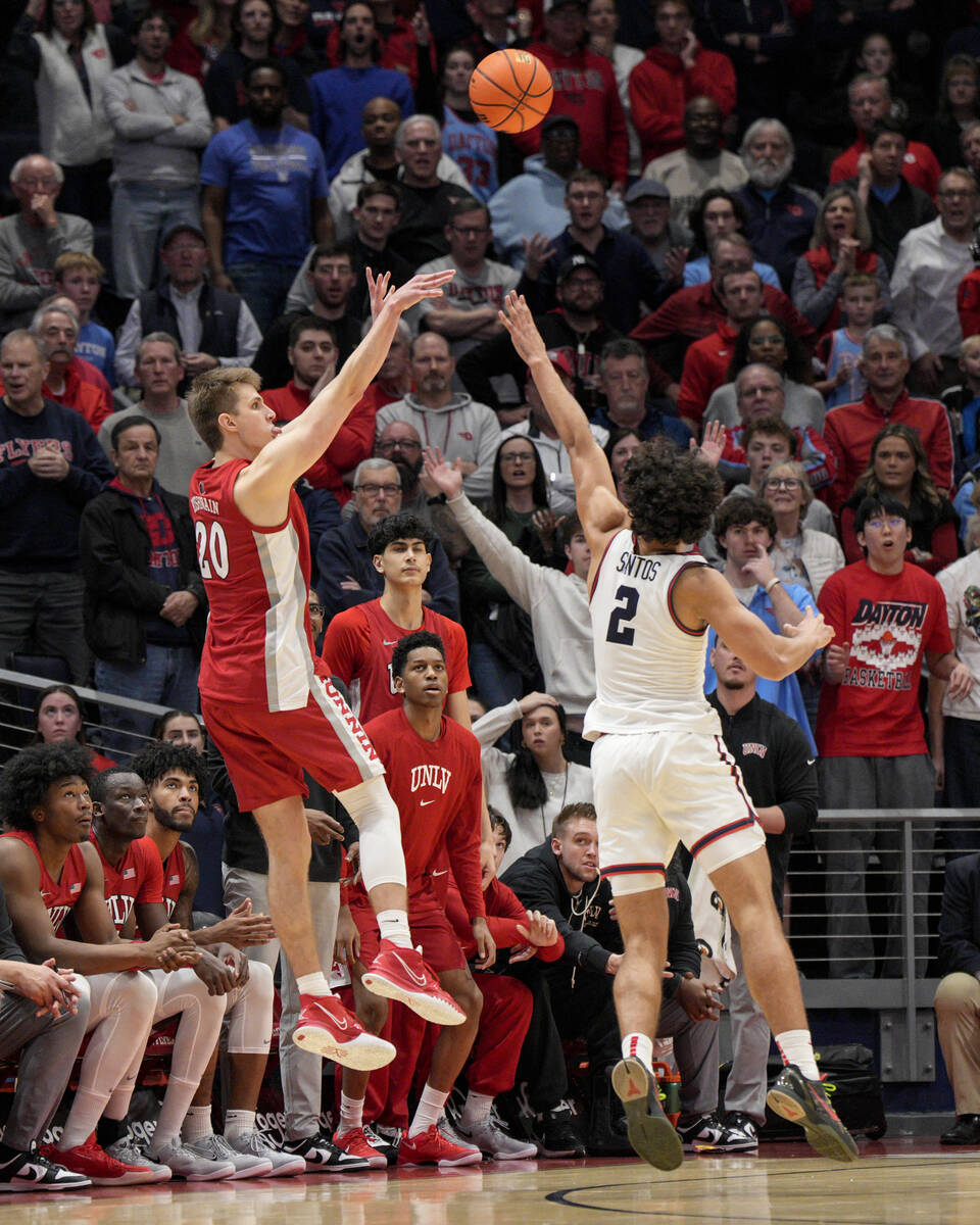 UNLV guard Julian Rishwain (20) shoots against Dayton forward Nate Santos (2) during an NCAA co ...