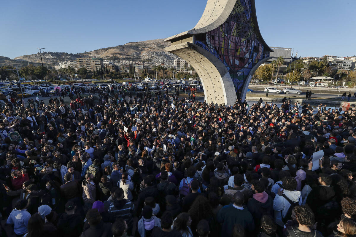 Syrian activists gather at the Umayyad square during a protest to demand a secular state, in Da ...