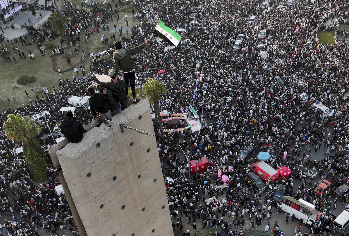 Syrians continue to celebrate the ousting of Bashar al-Assad's government, at Umayyad Square, i ...