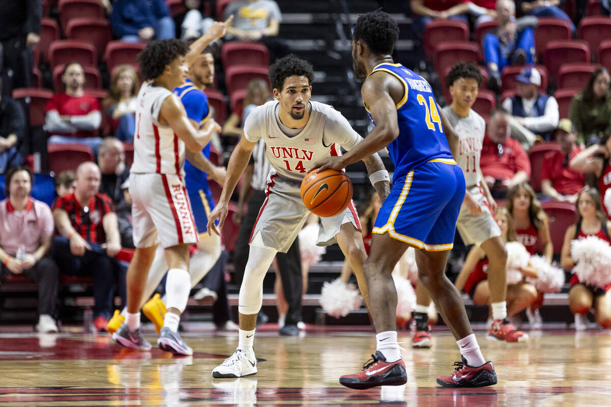 UNLV guard Jailen Bedford (14) watches UC Riverside Highlanders guard Barrington Hargress (24) ...