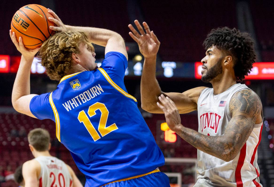 UC Riverside Highlanders center Jack Whitbourn (12) looks to pass the ball past UNLV forward Is ...