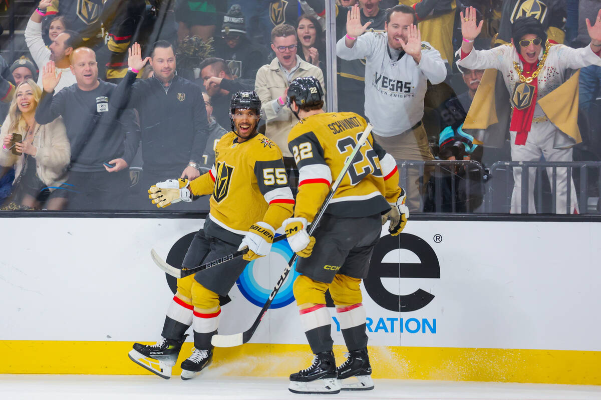 Golden Knights right wing Keegan Kolesar (55) celebrates a goal with Golden Knights right wing ...