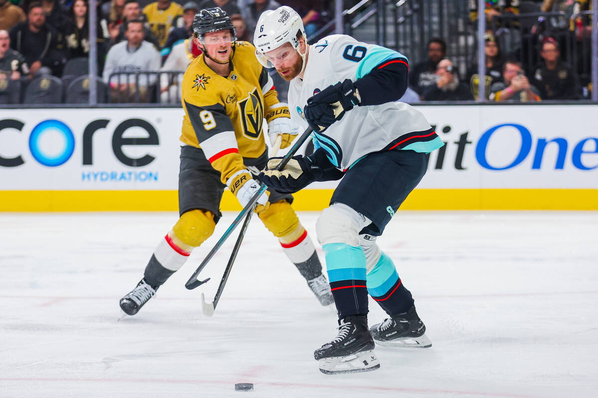 Golden Knights center Jack Eichel (9) loses the puck as Seattle Kraken defenseman Adam Larsson ...