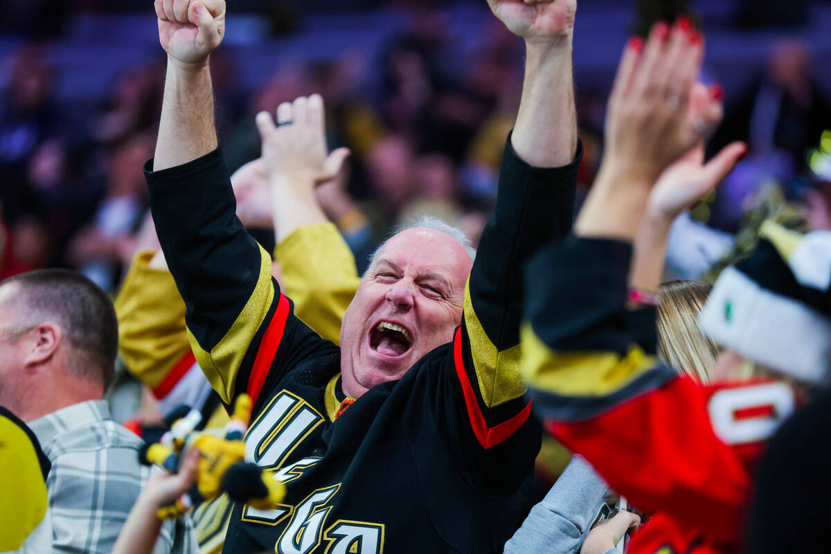 A Golden Knights fan celebrates a goal during an NHL hockey game between the Golden Knights and ...