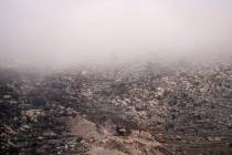 An Israeli bulldozer maneuvers on the buffer zone near the so-called Alpha Line that separates ...