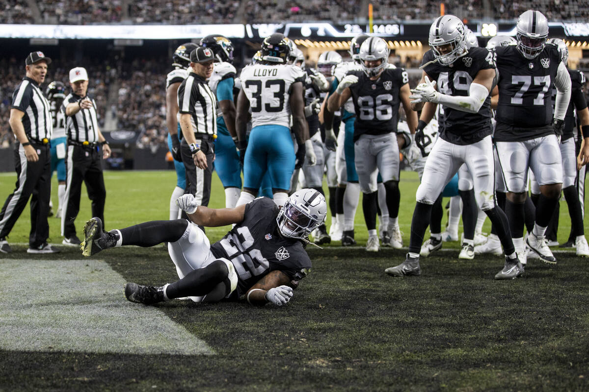 Raiders running back Alexander Mattison (22) rolls into the end zone, scoring a touchdown durin ...