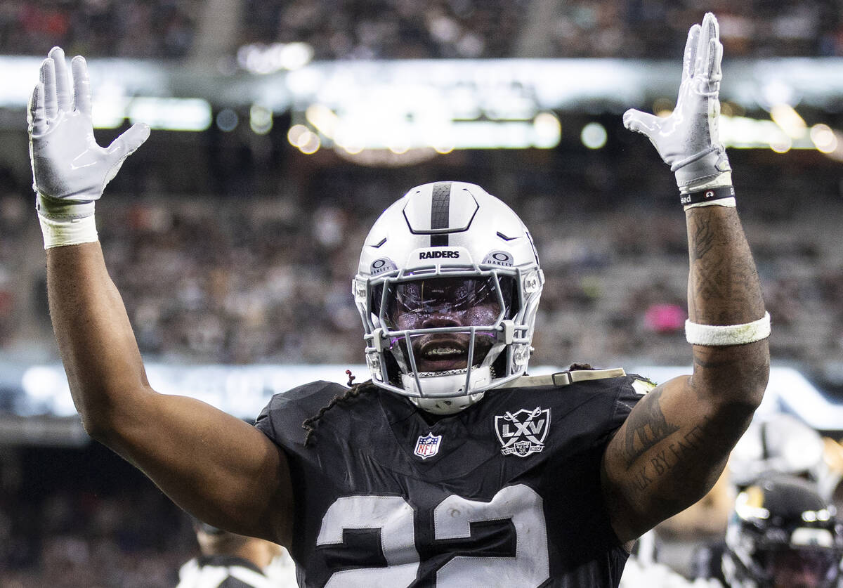 Raiders running back Alexander Mattison (22) celebrates after scoring a touchdown during the fi ...