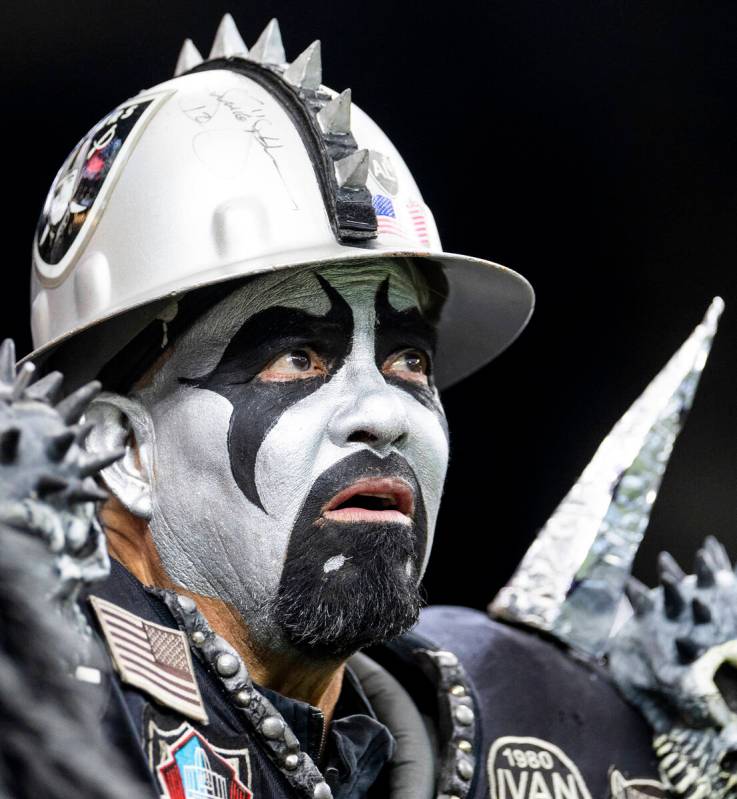 A Raiders fan watches a replay on the scoreboard during the first half of the NFL game against ...