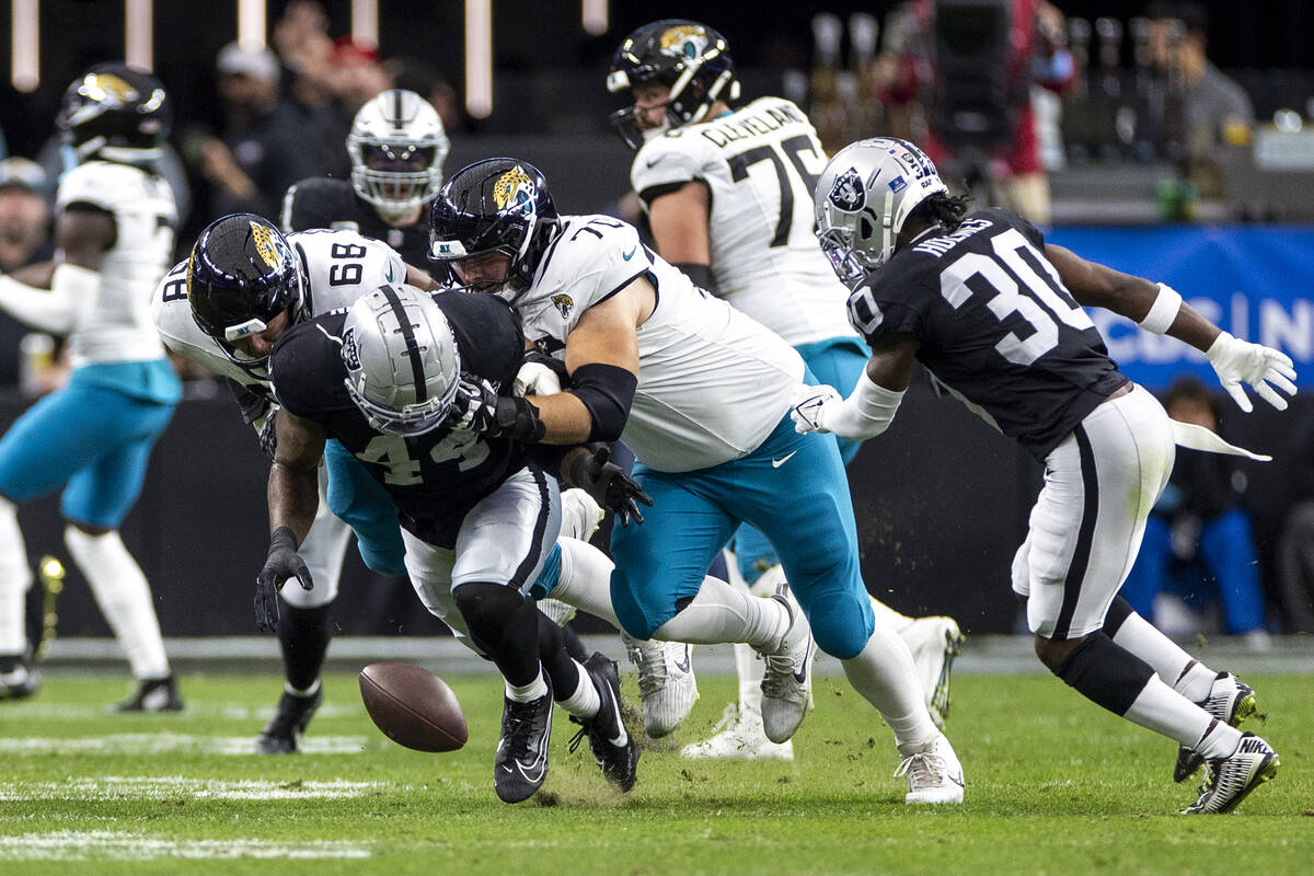 Raiders defensive end K'Lavon Chaisson (44) loses control of the ball after intercepting a pass ...